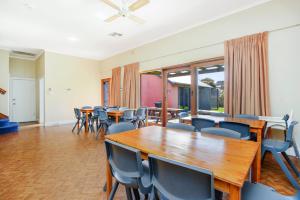 a conference room with wooden tables and chairs at Beachfront Bliss - Wi-fi Bbq Group House in Victor Harbor