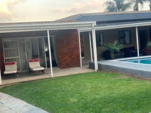 a house with a patio and a swimming pool at Horizon Bed and Breakfast in Roodepoort