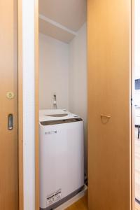 a small kitchen with a sink and a refrigerator at ROMANTIC FLAT IN THE HEART OF SHIBUYA / 7MIN WALK in Tokyo
