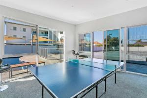 a ping pong table in the middle of a room at Gallery Resort Style Penthouse No 13 in Victor Harbor