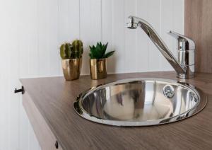 a kitchen sink with two potted plants on a counter at Glamping Chateau de La Chapelle in Anthisnes