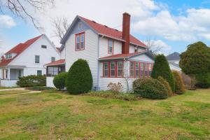 a large white house with a red roof at Clinton Street Retreat -Dog Friendly- Close to downtown in South Haven