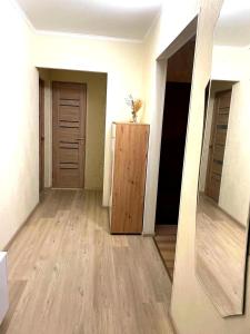 a room with a hallway with two doors and a mirror at Автовокзал in Rivne +3 photos