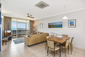 a living room with a couch and a table at 'The Dolphins 7' - Beachfront View To Remember in Port Elliot