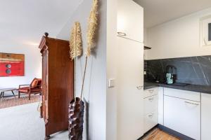 a kitchen with white cabinets and a refrigerator at Great Stay in Boll in Bad Boll