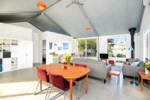a living room with a table and a couch at Pelican Cottage - Pet Friendly - Wifi in Goolwa North