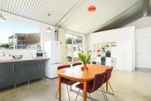 a kitchen with a wooden table and chairs at Pelican Cottage - Pet Friendly - Wifi in Goolwa North