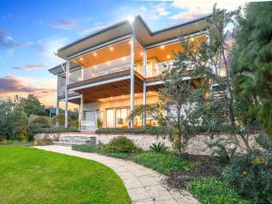 a home with a large building with a yard at Muse On The Murray Pet-friendly in Wellington