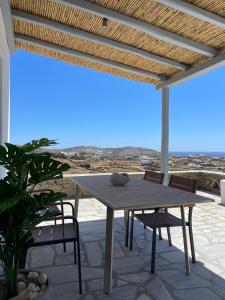 a wooden table and chairs on a patio at Agyra House in Super Paradise Beach