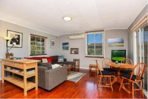 a living room with a couch and a table at Milly's Middleton - Pet-friendly in Middleton