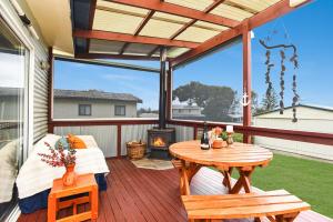 a screened in porch with a table and a fireplace at Milly's Middleton - Pet-friendly in Middleton