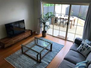 a living room with a couch and a tv at Norwood Saltbush Retreat With Wifi in Norwood