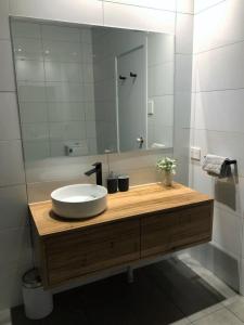 a bathroom with a sink and a large mirror at Norwood Saltbush Retreat With Wifi in Norwood