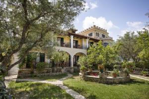 an exterior view of a large house with trees at Castellos Bellos Studio 2 in Marathias