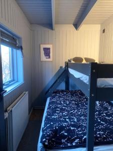 ein Schlafzimmer mit einem Etagenbett und einem Fenster in der Unterkunft Heart of the Golden Circle with Hot Tub in Selfoss