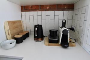 a kitchen counter with a coffee maker and other appliances at Southern Sands' Beachfront Apartment in Port Elliot