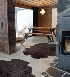 a living room with a table and a fireplace at Lapland Hygge in Rovaniemi +28 photos