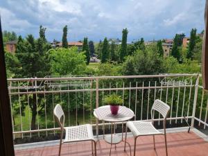 a balcony with a table and chairs and a view at Casa della Zia Lina in Parma