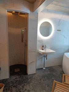 a bathroom with a shower and a sink at Lapland Hygge in Rovaniemi