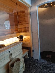 a small bathroom with a shower and a sink at Lapland Hygge in Rovaniemi