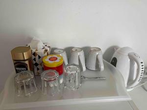 a white shelf with some glass items on it at St Pancras Private Rooms in London