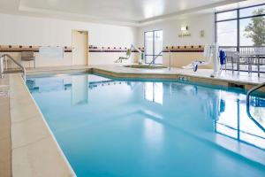 a large swimming pool with blue water at SpringHill Suites by Marriott Cheyenne in Cheyenne