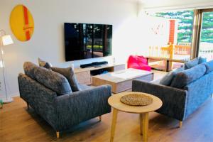 a living room with two couches and a table at Vista Victor Harbor Beachfront Apartment No 4 in Victor Harbor