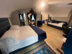 a bedroom with a large bed and a living room at Rome luxury blue suites- IMPERIAL in Rome