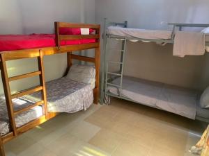 a room with three bunk beds in a room at JUCENTE_ALOJAMENTO_LOCAL in Quifica