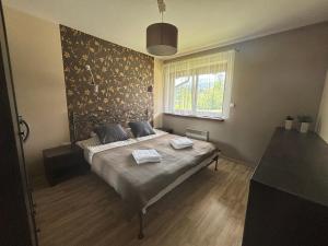 Posteľ alebo postele v izbe v ubytovaní Apartament Widokowy