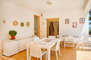 uma cozinha e sala de jantar com mesa e cadeiras em Villa Azzurra em Castellammare del Golfo