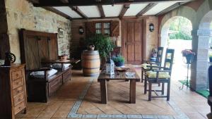a living room with a table and a barrel at Gaztañeta Baserria in Olaeta