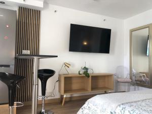 a bedroom with a bed and a tv on the wall at Luxury Studio Costa del Sol in Torremolinos