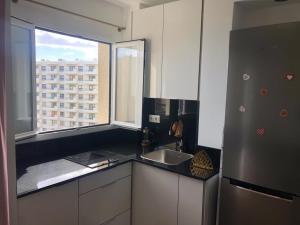 a kitchen with a refrigerator and a sink and a window at Luxury Studio Costa del Sol in Torremolinos