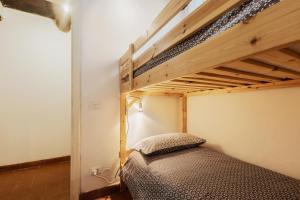 a bedroom with a bunk bed with a ladder at Stella Alpina Nordic Style and Relax in Levigliani