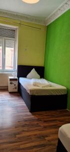 una camera con un letto con una parete verde di WOHNUNG IN KAISERSLAUTERN a Kaiserslautern