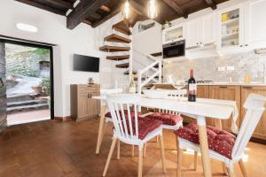 a kitchen with a table and chairs and a staircase at Stella Alpina Nordic Style and Relax in Levigliani