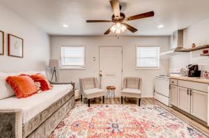 a living room with a bed and a ceiling fan at Charming Getaway in Stillwater in Stillwater