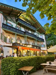 a large building with people sitting outside of it at Hotel Terofal in Schliersee