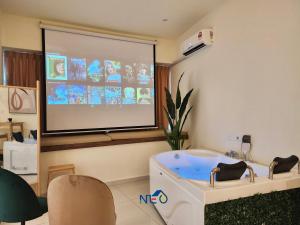a large projection screen in a room with a tub at Country Garden Danga Bay InStyle Sea View Homestay Suite by NEO in Johor Bahru