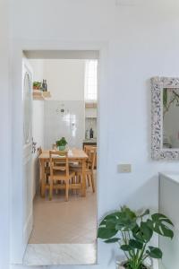 a kitchen and dining room with white walls and a table at Franci House in Sant'Agnello +12 photos