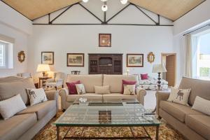 a living room with a couch and a table at Finca La Fuensanta in Arcos de la Frontera