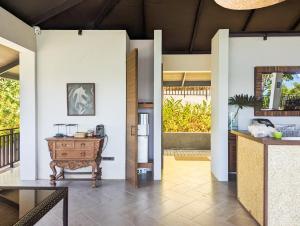 a living room with a table and a refrigerator at Perch El Nido's Seaview Villas overlooking Marimegmeg in El Nido