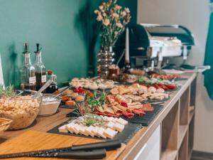 a buffet with many different types of food on a table at Dom Wczasowy Larix in Rewal