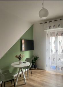 a dining room with a white table and chairs at Mami home in Cormano