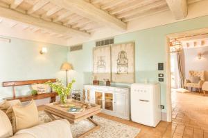 a living room with a couch and a table at Podere Val D'Orcia - Tuscany Equestrian in Sarteano