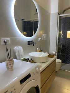 a bathroom with a washing machine and a sink at Casa Don Saro in Giardini Naxos