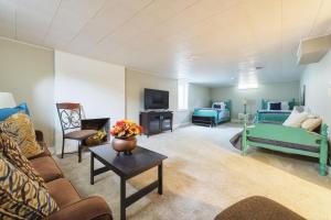 a living room with a couch and a tv at Garden Getaway - Walking Distance to downtown Douglas - Cute Home! in Douglas