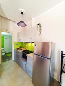 a kitchen with a stainless steel refrigerator at Green Studio Nidri in Nydri