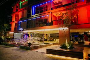 a building with colorful lights on it at night at Unity #421 - Praia de Cabo branco por Carpediem in Penha +33 photos